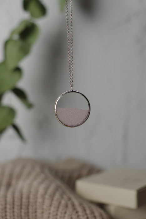 Pink ball perpetual motion necklace