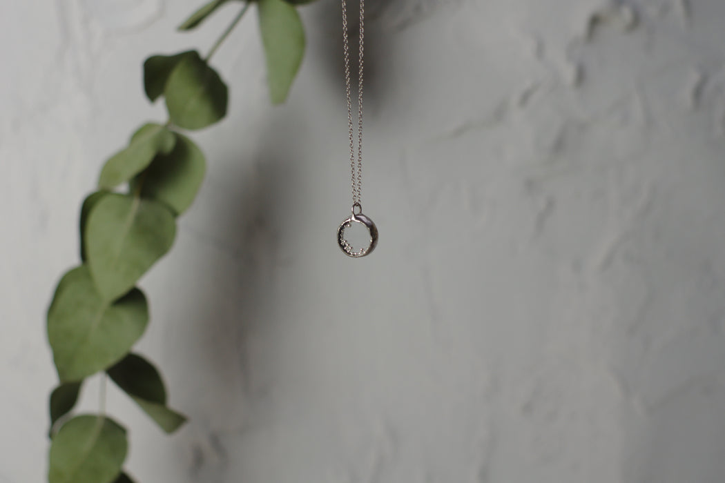 Small perpetual motion necklace with silver balls